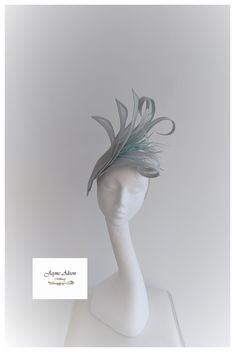 Stunning hatinator in duckegg blue, pale aqua sinamay.   Large petals create a striking effect whilst the elongated petals curl and twist to create a beautiful shape.  A cluster goose biot and coq feathers create movement on this simply elegant headpiece. Sits on a headband. This item has sold, however, similar pieces can be made in a variety of colours.  Please ask for details.  As every piece is handmade, some differences can occur from the photos listed on this site.  Made to order/bespoke/cu Elegant Headpiece, Fashion Competition, Pale Aqua, Wedding Fascinators, Royal Ascot, Wedding Hats, Kentucky Derby, Ladies Day, Fascinator