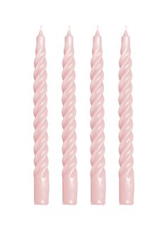 three pink candles sitting next to each other