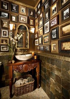 a bathroom with pictures on the wall and a sink in it's center area