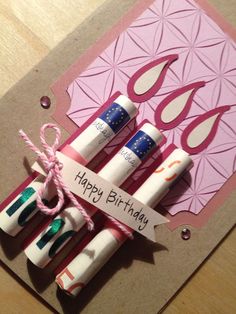 a birthday card with four candles tied up to each other on top of a table