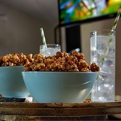 two bowls filled with granola sitting on top of a table next to a remote control