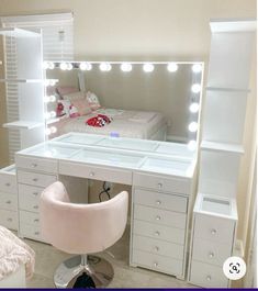 a white vanity table with lights on it