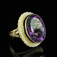 Amethyst Ring Victorian Style Cocktail Large Oval Seed Pearls Yellow Gold Bezel Set Gemstone There is nothing subtle and delicate about this ring. Flashy, expensive looking ring made of 14K yellow gold with a luxurious looking, large, oval amethyst (approximately 12ct) set in bezel and surrounded by a halo of gold twisted wire and oriental seed pearls. Sizes: 4-8 (smaller and larger sizes are available as custom orders.) PROUDLY MADE FROM SCRATCH IN NEW YORK CITY. Please allow 2-3 weeks to compl Art Deco Pearl, Oval Amethyst Ring, Pearls Ring, Seed Pearl Ring, Bijoux Art Nouveau, Nature Inspired Engagement Ring, Pearl Rings, Bezel Set Ring, Purple Jewelry