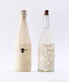 two empty bottles are sitting next to each other