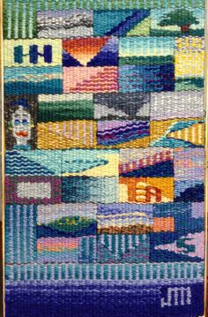 a cross stitched wall hanging with many different colors and designs on it's side