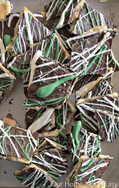 there are many pieces of chocolate with green and white icing