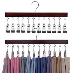 an assortment of clothes hanging from hooks on a wooden hanger with metal clips attached to it