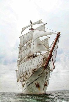 an old sailing ship in the middle of the ocean