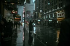 people walking down the street on a rainy day in new york city at night time