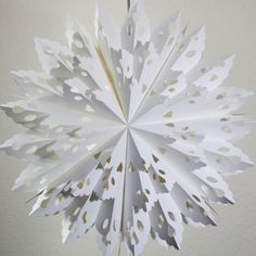 a paper snowflake hanging from the ceiling