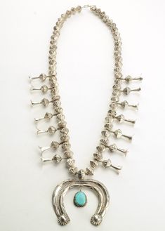 "Vintage Native American Squash Blossom circa 1970 Strung on Steel Wire This necklace is 26 inches long The necklace has 11.3 mm (Hand made, fluted) beads and 1 3/8 inch long blossoms The Naja (Pendant) on this necklace measures 2 1/2\" x 2\" This necklace weighs a substantial 110.2 grams, yet it's worn very comfortably The stone/design of this necklace is Natural Fox Turquoise Mine Markings: none, typical for older Native American jewelry to be not signed we guaranty the metal content to be ste Vintage Squash Blossom Necklace, Naja Pendant, Turquoise Squash Blossom, Vintage Silver Jewelry, Native American Turquoise, Squash Blossom Necklace, American Turquoise, Squash Blossom, Silver Prices