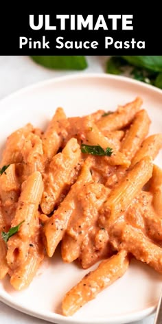 a white plate topped with pasta covered in sauce