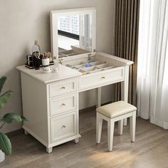 a white dressing table with a stool and mirror in front of it on top of a hard wood floor