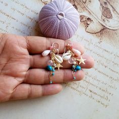 "Made to order. Important information on current production times may be found on the shop policies page or in the shop announcement. Now my long gemstone dangle earrings are available in a shorter version! *The first eight pictures are in gold filled, and the last is in sterling silver. ~ starfish, cowrie shells, sleeping beauty turquoise, pink Peruvian opal, rose quartz, larimar, turquoise, coral, grapefruit quartz, freshwater pearls, Swarovski crystals, angel skin coral ~ gold filled, rose go Ocean-inspired Dangle Single Earring, Ocean-inspired Single Dangle Earring, Turquoise Dangle Earrings With Ocean-inspired Style, Turquoise Dangle Earrings Ocean-inspired, Beach Jewelry With Dangling Charms, Ocean-inspired Turquoise Dangle Jewelry, Handmade Ocean-inspired Drop Earrings, Handmade Ocean-inspired Dangle Jewelry, Artisan Turquoise Earrings For Beach