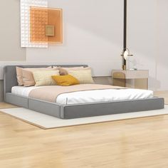 a bed sitting on top of a hard wood floor