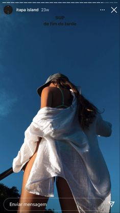 a woman wearing a white dress and hat