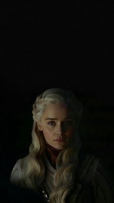 game of thrones'daeneress starke is looking at the camera while standing in front of a dark background