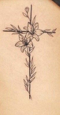 a cross with flowers on the back of a woman's neck and lower back