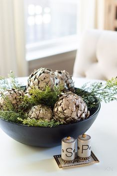 some pine cones are in a bowl on a table