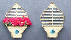 two wooden wall hangings with flowers in them