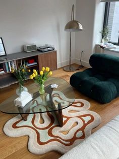 a living room filled with furniture and a glass table