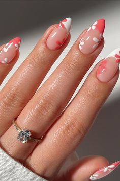 a woman's hand with pink and white nail polish