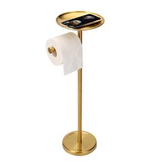 a gold toilet paper holder with a cell phone on it and a roll of tissue