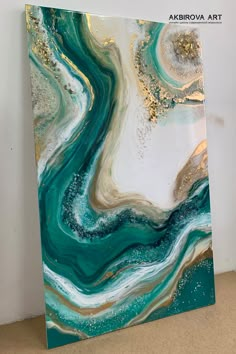 an abstract painting with gold and blue colors on the bottom, it looks like fluid paint