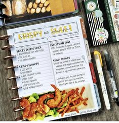 an open recipe book sitting on top of a wooden table next to other food items