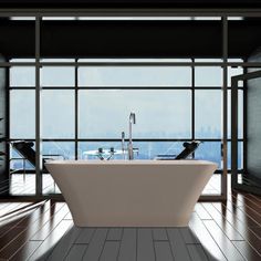 a bath tub sitting in front of a large window