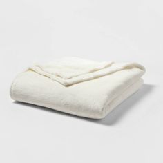 a white blanket folded on top of each other