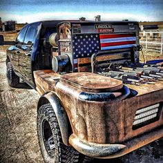 an old truck with the american flag painted on it