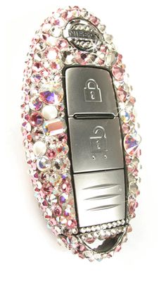 a cell phone is covered in pink and white jewels