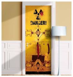 an open door with the words danger painted on it in front of a yellow wall