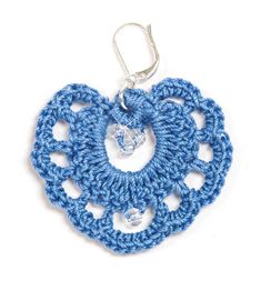 a crocheted heart is hanging from a hook