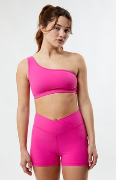 Make a bold statement with your activewear by rocking the PAC 1980 Active Bold Ribbed One Shoulder Top. Designed for both style and performance, this sports top features a trendy one-shoulder design and an asymmetrical neckline, providing a unique and fashion-forward look for your workouts. Crafted with comfort in mind and using a buttery soft ribbed fabrication with added stretch, this crop top ensures you stand out while staying comfortable during your active pursuits. 


	Solid color top
	Lined; Unpadded
	Buttery soft
	Ribbed fabric
	Good stretch
	Asymmetrical neckline
	One shoulder design
	Elastic band
	Cropped length
	HD silicone P logo
	Fitted
	Fits true to size
	90% nylon, 10% lycra
	Machine washable
	Model is wearing a size xsmall
	Model measurements: 5’6.5” height Trendy High Stretch Activewear For Sports, Trendy High-stretch Sports Activewear, Ribbed Athleisure Activewear For Training, Trendy Medium Support Sports Activewear, Ribbed Athleisure Workout Tops, Ribbed Athleisure Tops For Workout, Trendy Ribbed Activewear For Yoga, Trendy High-stretch Sports Bra, Sporty Ribbed Activewear For Training