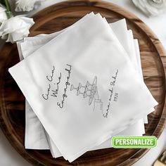 four personalized napkins on top of a wooden plate