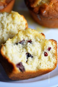 muffins with cranberries are sitting on a plate