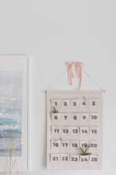 a calendar hanging on the wall next to a christmas tree and other holiday decor items