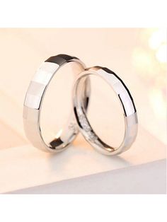 two wedding rings sitting on top of each other