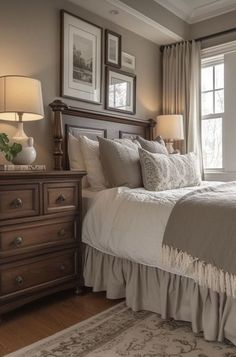 a large bed sitting under two windows in a bedroom