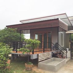 a small house sitting on top of a lush green field