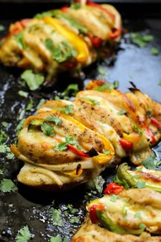 some food is laying out on a black tray and ready to be cooked in the oven