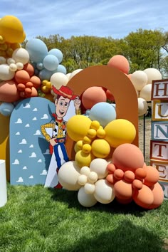 an outdoor event with balloons and decorations