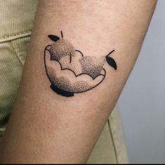 a tattoo on the arm of a person with a sheep head and leaves in it