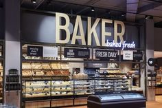 the bakery is stocked with fresh bread and baked goods for sale in the store's display case