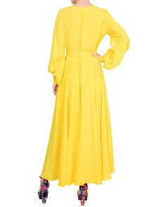 This 70's inspired maxi dress features a sexy cross front V-shaped surplice neckline. The elasticized waist adjusts to fit a range of sizes and has an attached self-tying belt at the right-hand side seam. The cuffed bell sleeves add a hint of retro glamour. The opaque fabric has a butter-soft hand with a vibrant, canary yellow hue. The full, sweeping circle maxi skirt is perfect for making a dramatic entrance to any event. The skirt is partially lined. ** Based on the settings of your display, c Circle Maxi Skirt, Dramatic Entrance, Retro Glamour, Surplice Neckline, Medium Dress, Mid Length Skirts, 70s Inspired, Dress Pant, Soft Hand