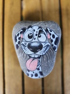 a rock with a cartoon dog painted on it