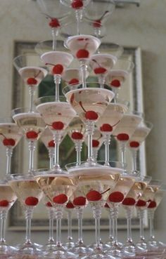 there are many wine glasses stacked on top of each other in the shape of a pyramid