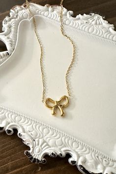 Get ready to amp up your style with our adorable Dainty Bow Necklace! Wrap yourself in charm and sweet simplicity with this gorgeous necklace featuring a tiny bow pendant. Timeless Design: The delicate bow design adds a timeless and feminine touch to your style. High-Quality Stainless Steel: Crafted with precision and durability in mind, our necklace is made from high-quality stainless steel, ensuring longevity and resistance to tarnish. Versatile Finishes: Choose between the classic elegance of Feminine Ribbon Necklace As Gift, Feminine Ribbon Necklace For Gift, Feminine Bow Jewelry For Gift, Dainty Bow Necklace For Gift, Dainty Bow Necklace For Gifts, Elegant Necklace With Decorative Bow For Gift, Delicate Ribbon Necklace Gift, Chic Ribbon Jewelry As A Gift, Delicate Ribbon Necklace For Gift